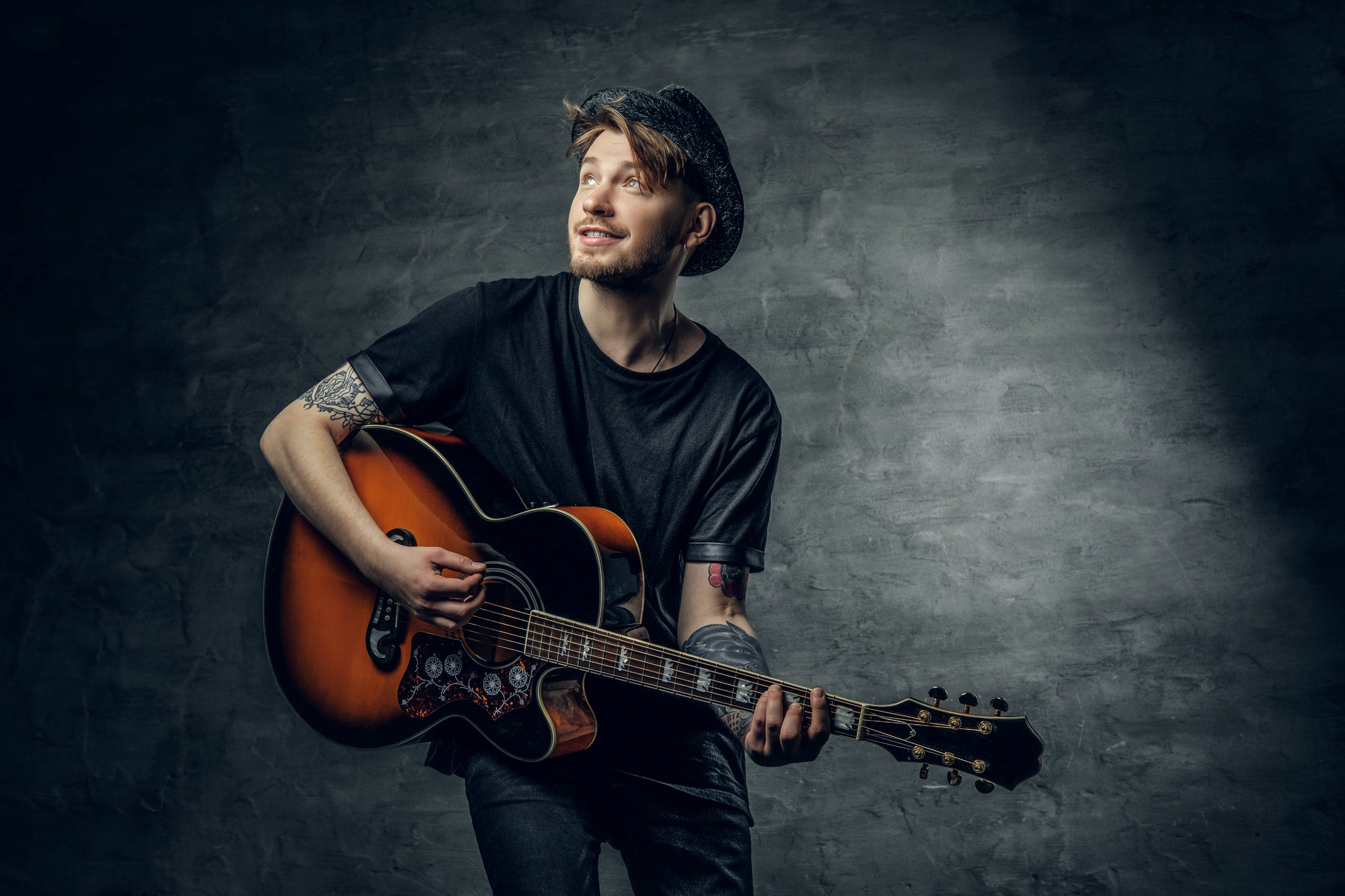 handsome-young-acoustic-guitar-blues-player-with-tattoos-on-arms-.jpg